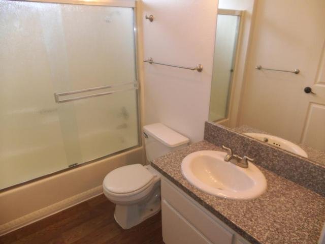 Bathroom With Granite And Glass Shower Door